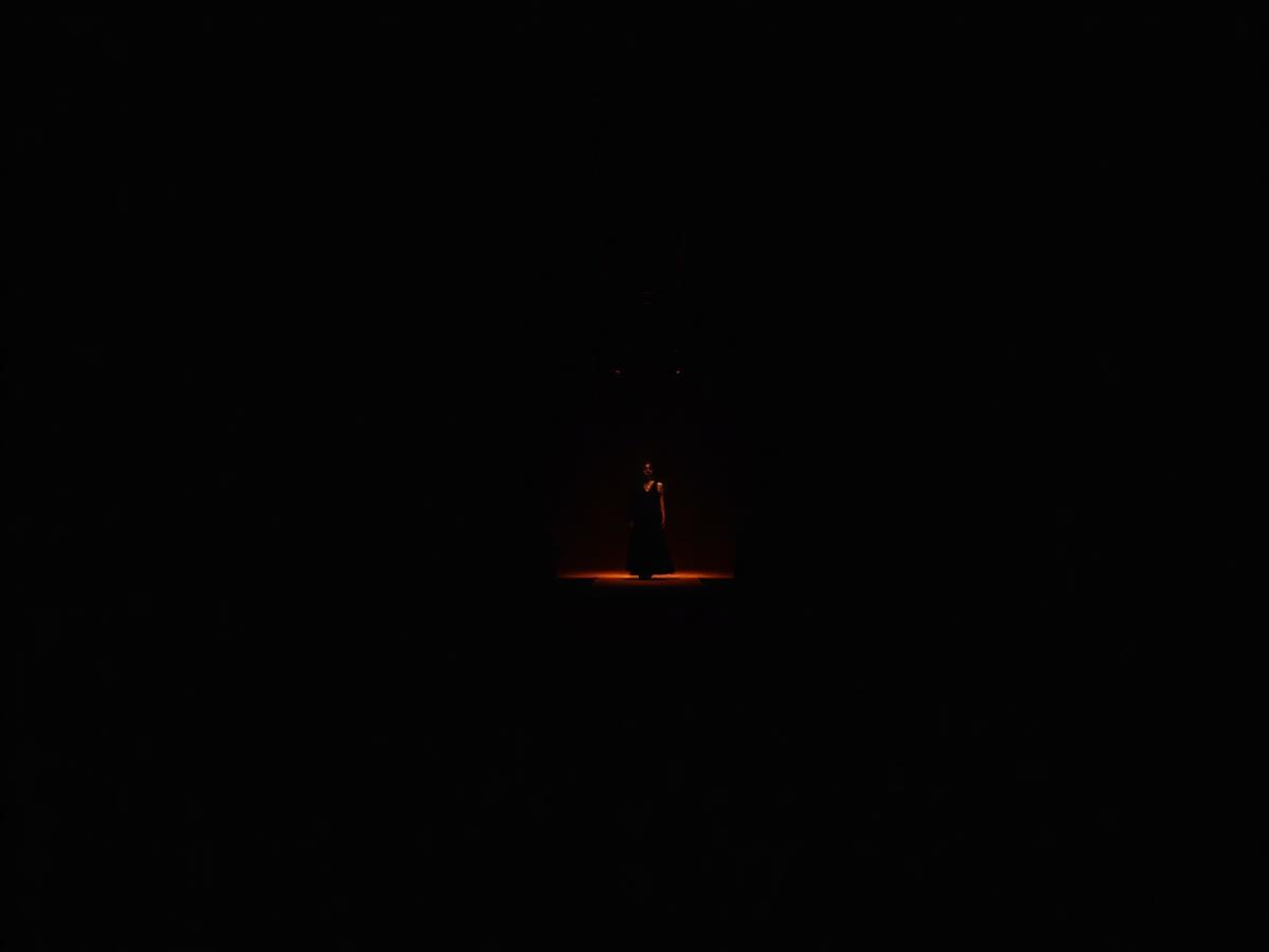 Dark runway lit by a single warm spotlight